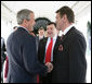 President George W. Bush and Ukraine President Viktor Yushchenko shake hands upon Mr. Yushchenko's departure Monday, April 4, 2005, following his visit to the White House.White House photo by Eric Draper