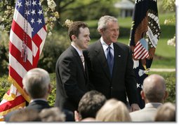 President George W. Bush and Jason Kamras, 2005 National Teacher of the Year, stand for photos in the Rose Garden Wednesday, April 20, 2005, after Mr. Kamras, a 7th and 8th grade math teacher at John Philip Sousa Middle School in Washington, D.C., was honored for his work. White House photo by Krisanne Johnson