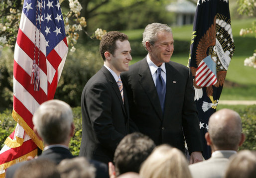 President George W. Bush and Jason Kamras, 2005 National Teacher of the Year, stand for photos in the Rose Garden Wednesday, April 20, 2005, after Mr. Kamras, a 7th and 8th grade math teacher at John Philip Sousa Middle School in Washington, D.C., was honored for his work. White House photo by Krisanne Johnson