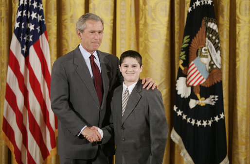 President George W. Bush congratulates James Quadrino, Jr., 13, of the Elias Bernstein School on Staten Island, N.Y., on receiving the President’s Environmental Youth Award in the East Room of the White House April 21, 2005. White House photo by Paul Morse