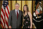 President George W. Bush congratulates Heather Renee Dornan, 18, of Del City High School Water Watch Program Student Volunteers of Del City, Okla., on receiving the President’s Environmental Youth Award in the East Room of the White House April 21, 2005. White House photo by Paul Morse