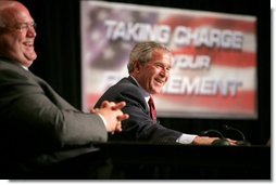 President George W. Bush shares a light moment with Jim Yarbrough, left, County Judge of Galveston County, during a roundtable discussion on Strengthening Social Security at the University of Texas Medical Branch in Galveston, Texas, Tuesday, April 26, 2005.  White House photo by Eric Draper