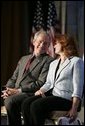 President George W. Bush shares the spotlight with Marianne Sensale-Guerin, 2005 SBA National Small Business Person of the Year, during his address to the National Small Business Week Conference in Washington, D.C., Wednesday, April 27, 2005. White House photo by Paul Morse