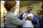 Laura Bush signs the shirt of a member of Homeboy Industries in Los Angeles April 27, 2005. Homeboy Industries is an job-training program that educates, trains and finds jobs for at-risk and gang-involved youth. White House photo by Krisanne Johnson