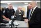 Vice President Dick Cheney, Senator Saxby Chambliss, and Department of Homeland Security Secretary Michael Chertoff listen as a U.S. Customs and Border Protection agent shows off some of the technology being used to train law enforcement personnel at the Federal Law Enforcement Training Center in Glynco, Georgia, May 2, 2005. The Vice President toured the facility, which provides training to more than 80 federal agencies, in addition to state and local police. The facility is the largest law enforcement training establishment in the country and graduates over 50,000 students annually. White House photo by David Bohrer