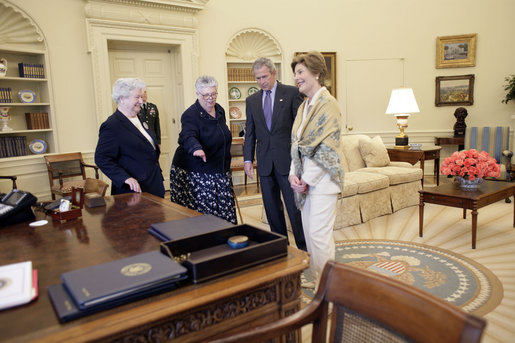 President George W. Bush and Laura Bush discuss some of the history of the Oval Office Agnes Chouteau, left, and Lorraine Stange both of Missouri Monday, May 2, 2005. The two women are recipients of the 2005 Preserve America Presidential Award. White House photo by Eric Draper