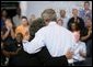 President George W. Bush hugs stage participant DeLois Killen Tuesday, May 3, 2005, at the end of a Conversation on Strengthening Social Security at the Nissan North America Manufacturing Plant in Canton, Miss. Mrs. Killen, a full-time dispatcher at the Union (Mississippi) Police Station, is not worried about losing her benefits -- which she relies on heavily -- but she believes that changes to Social Security are necessary. White House photo by Eric Draper