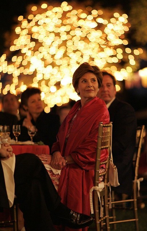 Laura Bush listens to a mariachi band perform during the White House celebration of Cinco de Mayo songs in the Rose Garden of the White House Wednesday, May 4, 2005. White House photo by Paul Morse