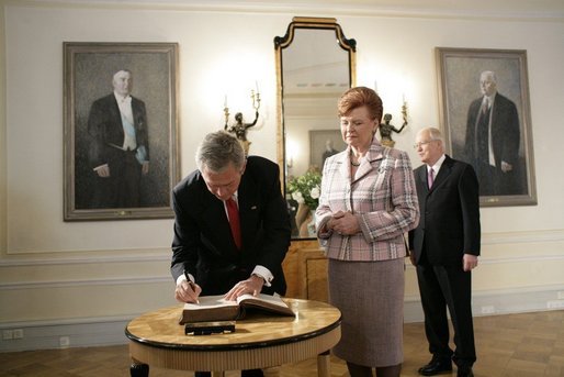 President George W. Bush signs a guest book after Latvian President Vaira Vike-Freiberga presented him the Order of the Three Stars, First-Class at Riga Castle in Riga, Latvia, Saturday, May 7, 2005. Established in 1924 to commemorate the founding of the Latvian State, the medal is awarded to recognize outstanding civil merit in the service of Latvia. White House photo by Eric Draper