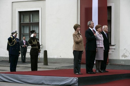 President George W. Bush and Laura Bush and Latvia President Vaira Vike-Freiberga and husband Imants Freibergs stand for the playing of the American national anthem Saturday, May 7, 2005, at Riga Castle in Riga, Latvia. White House photo by Eric Draper