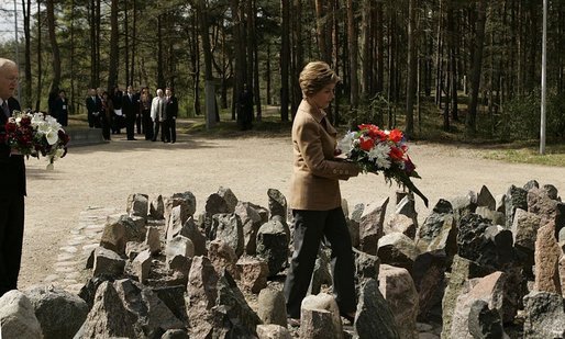 Laura Bush lays flowers at the Rumbula Holocaust Memorial in Riga, Latvia, Saturday, May 7, 2005. White House photo by Eric Draper