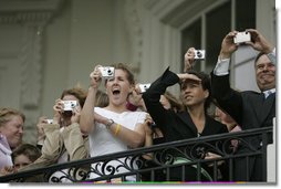 A crowd watches from the Truman balcony as President George W. Bush and Laura Bush depart the South Lawn aboard Marine One Friday, May 13, 2005.  White House photo by Paul Morse