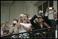 A crowd watches from the Truman balcony as President George W. Bush and Laura Bush depart the South Lawn aboard Marine One Friday, May 13, 2005. White House photo by Paul Morse