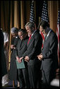 President George W. Bush joins his hosts in prayer while attending the National Catholic Prayer Breakfast in Washington, D.C., Friday, May 20, 2005. White House photo by Eric Draper