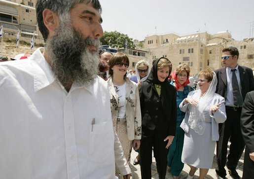 Laura Bush departs the Western Wall after inserting a prayer in the wall and taking a tour of the model of Mount Moriah Sunday, May 22, 2005. White House photo by Krisanne Johnson