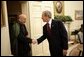 President George W. Bush welcomes Afghanistan President Hamid Karzai into the Oval Office Monday, May 23, 2005, following his arrival to the White House. White House photo by Eric Draper