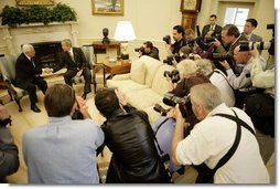 President George W. Bush shakes hands with President Mahmoud Abbas of the Palestinian Authority Thursday, May 26, 2005, as the press records the moment in the Oval Office of the White House. White House photo by Eric Draper