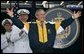 President George W. Bush tries on a Navy jacket during U.S. Naval Academy graduation ceremony in Annapolis, Md., Friday, May 27, 2005. White House photo by Paul Morse