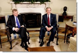 President George W. Bush and Jaap de Hoop Scheffer, Secretary General of NATO, sit for the media in the Oval Office of the White House Wednesday, June 1, 2005. White House photo by Paul Morse