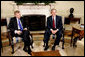 President George W. Bush and Jaap de Hoop Scheffer, Secretary General of NATO, sit for the media in the Oval Office of the White House Wednesday, June 1, 2005. White House photo by Paul Morse