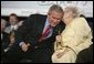 President George W. Bush leans in for a whisper from Cecil Ferrell, founder and owner of Ferrell’s Hamburgers in Hopkinsville, Ky., one of the participants in the President's Conversation on Strengthening Social Security Thursday, June 2, 2005, at the Hopkinsville Christian County Conference and Convention Center. White House photo by Eric Draper