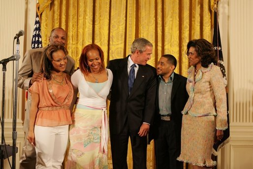 President George W. Bush celebrates Black Music Month Monday, June 6 2005, in the East Room of the White House. With him from left are artists: Reverend Donnie McClurkin; sisters Erica and Tina Campbell of Mary Mary; Smokie Norful, and Teresa Hairston, founder an publisher of Gospel Today and emcee of the event. White House photo by Krisanne Johnson