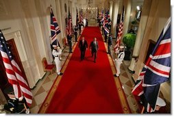 President George W. Bush and British Prime Minister Tony Blair walk together to address the waiting press in the East Room Tuesday, June 7, 2005. "Together our two nations worked to liberate Europe from fascism; together we defended freedom during the Cold War," President Bush in his statement. "Today we're standing together again to fight the war on terror, to secure democracy and freedom in Iraq and Afghanistan and the broader Middle East, and to prevent the spread of weapons of mass destruction."  White House photo by Paul Morse