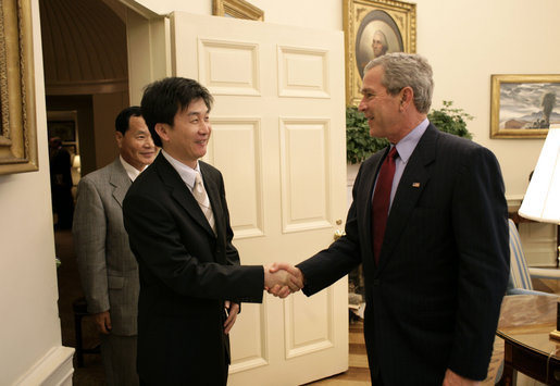 President George W. Bush welcomes Chol-hwan Kang to the Oval Office Monday, June 13, 2005. Mr. Kang is the author of, “The Aquariums of Pyongyang: Ten Years in the North Korean Gulag.” Mr. Kang defected from North Korea and now lives in South Korea and works as a journalist. White House photo by Eric Draper