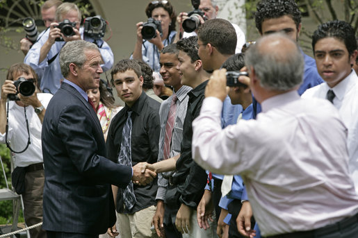 President George W. Bush greets some of the 200 exchange students he addressed in the Rose Garden Monday, June 13, 2005. Living with host families in America for one year, students from the many Muslim countries participate in the State Department program, Partnerships for Learning, Youth Exchange and Study. White House photo by Eric Draper