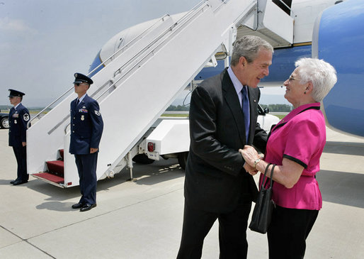 President George W. Bush talks with Freedom Corps Greeter Mickey Peters at University Park Airport in Pennsylvania Tuesday, June 14, 2005. Mickey has been a volunteer with the Centre County Cooperative Extension 4-H program for more than 40 years. White House photo by Eric Draper