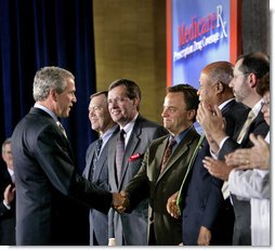 President George W. Bush greets Mark McClellan, Centers for Medicare and Medicaid Services Administrator, after speaking on Medicare at the U.S. Department of Health and Human Services Thursday, June 16, 2005. White House photo by Eric Draper