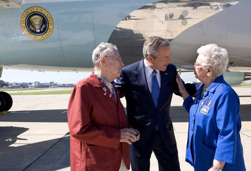 President George W. Bush talks with John and Agnes Jurek in front of Air Force One in Minneapolis Friday, June 17, 2005. The Jureks are volunteers with the Retired and Senior Volunteer Program (RSVP). They each have logged more than 4,000 hours since volunteering at the Veterans Affairs Medical Center in Minneapolis 16 years ago. White House photo by Eric Draper