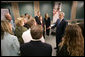 President George W. Bush talks with training volunteers for Medicare enrollment during a visit Friday, June 17, 2005, to a training session at the Maple Grove Community Center in Maple Grove, Minn. White House photo by Eric Draper