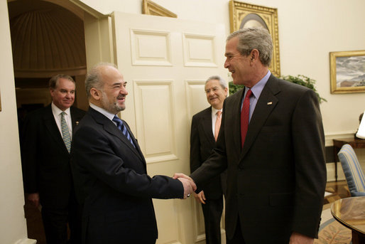 President George W. Bush shakes the hand of Iraq's Prime Minister Ibrahim Jaafari as he and U.S. Ambassador Donald Ensenat welcome the Prime Minister to the Oval Office Friday, June 24, 2005. Interpreter Gamal Helal stands in background. White House photo by Eric Draper