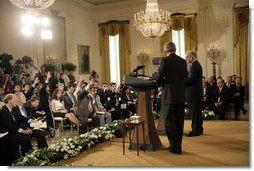 Members of the media raise their hands to President George W. Bush and Iraqi Prime Minister Ibrahim Jaafari during a media availability Friday, June 24. 2005, in the East Room of the White House.  White House photo by Eric Draper