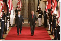 President George W. Bush walks with Dr. Ibrahim Jaafari, Prime Minister of Iraq, toward the East Room Friday, June 24, 2005, to meet the media.  White House photo by Paul Morse