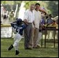 Shaquana Smith holds onto her hat as she runs to President George W. Bush and White House Tee Ball Commissioner Barry Larkin after her Memphis Red Sox played the Black Yankees of Newark during Sunday's "Tee Ball on the South Lawn." White House photo by Paul Morse