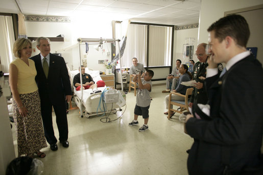 President George W. Bush poses with Stacy Beintema, the mother of Specialist Nicholas Beintema of Woodbridge, Calif., during a visit with wounded soldiers and their families at Walter Reed Army Medical Hospital Friday, July 1, 2005. White House photo by Eric Draper