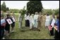 Mrs. Laura Bush looks on as Cherie Blair, wife of Prime Minister Tony Blair, takes the first dig during a tree-planting ceremony Thursday, July 1, 2005, at Glamis Castle, Scotland. White House photo by Krisanne Johnson