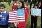 Children carrying US flags welcome Mrs. Bush and other spouses to the Spouses Program, hosted by Mrs. Cherie Blair, wife of Prime Minister Tony Blair of England, during the G8 Summit in Scotland Thursday, July 7, 2005. White House photo by Krisanne Johnson