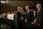 President George W. Bush shakes hands Monday, July 11, 2005, with Robert Mueller, Director of the Federal Bureau of Investigation as Porter Goss, right, Director of the Central Intelligence Agency, looks on. The President had just finished speaking on the war on terrorism at the FBI Academy in Quantico, Va. White House photo by Eric Draper