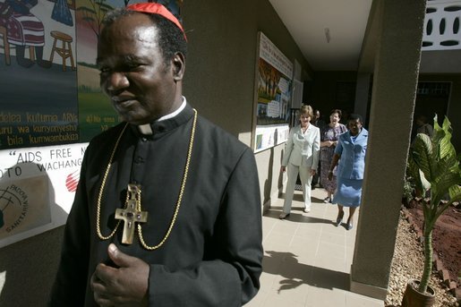 Led by Cardinal Polycarp Pengo, Laura Bush tours PASADA with Madame Anna Mkapa in Dar es Salaam, Tanzania, Wednesday, July 13, 2005. “For 13 years, the people of PASADA have provided services to men, women and children, whether they are infected with HIV or not. PASADA provides health education in communities, teaching teens and adults about the risks of HIV transmission,” said Mrs. Bush in her remarks. White House photo by Krisanne Johnson