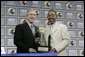 President George W. Bush receives the Black Expo Lifetime Achievement Award by Black Expo Chairman Arvis Dawson during the Indiana Black Expo Corporate Luncheon in Indianapolis, Indiana, Thursday, July 14, 2005. White House photo by Eric Draper