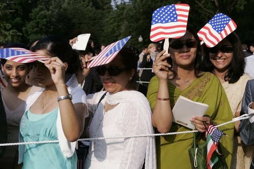 Invited guests shade their eyes, Monday, July 18, 2005 on the South Lawn of the White House for the arrival ceremony for the India PM. White House photo by Krisanne Johnson