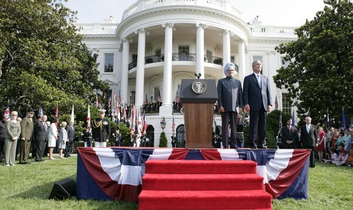 President Bush stands with India's Prime Minister Dr. Manmohan Singh, Monday, July 18, 2005 during the playing of the national anthems on the South Lawn of the White House. White House photo by Eric Draper