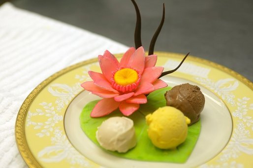 Three ice creams presented on a white chocolate lily pad with a lotus flower. White House Executive Pastry Chef Thaddeus DuBois created for the Official Visit of the Prime Minister of India July 18, 2005. White House photo by Shealah Craighead