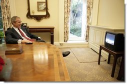 President George W. Bush watches the launch of the Space Shuttle Discovery in the Oval Office’s Private Dining Room Tuesday, July 26, 2005.  White House photo by Eric Draper