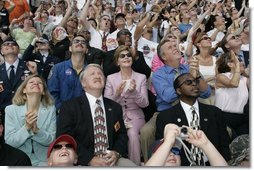 Laura Bush applauds as she folllows the launch of the Space Shuttle Discovery, Tuesday, July 26, 2005, at the Kennedy Space Center in Cape Canaveral, Florida. Mrs. Bush is joined by Florida Governor Jeb Bush, right, and NASA Astronaut Scott Altman, left.  White House photo by Krisanne Johnson