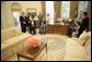 President George W. Bush gives a tour of the Oval Office after the signing of the Presidential Proclamation to Commemorate the 15th Anniversary of the Americans with Disabilities Act in the Oval Office Tuesday, July 26, 2005. President George H. W. Bush is pictured at center, left. White House photo by Eric Draper