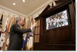  President George W. Bush smiles as he waves goodbye to the crew of the Space Shuttle Discovery Tuesday, Aug. 2, 2005, during a phone call from the Roosevelt Room of the White House. Before bidding the crew Godspeed and telling them to "get back to work," the President thanked them for being "risk-takers for the sake of exploration."  White House photo by Paul Morse